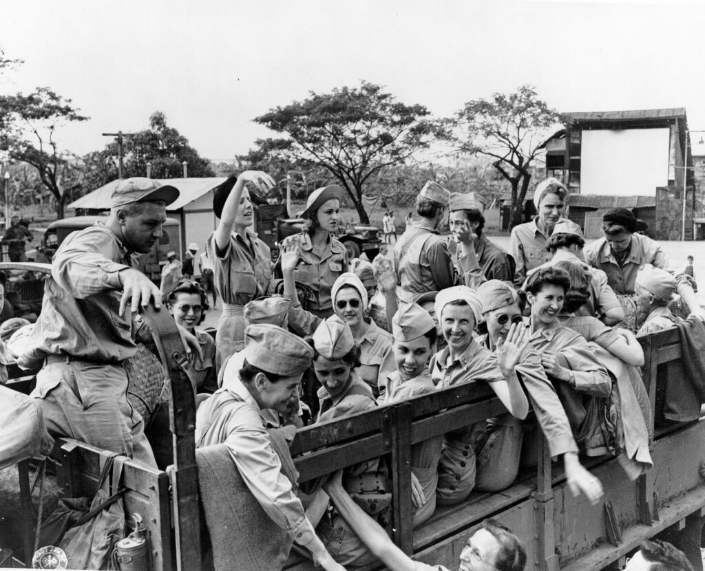 Black & White photograph of an army truck crammed full of army nurses, the Angels of Bataan held as prisoners of war and rescued fromSanto Tomas