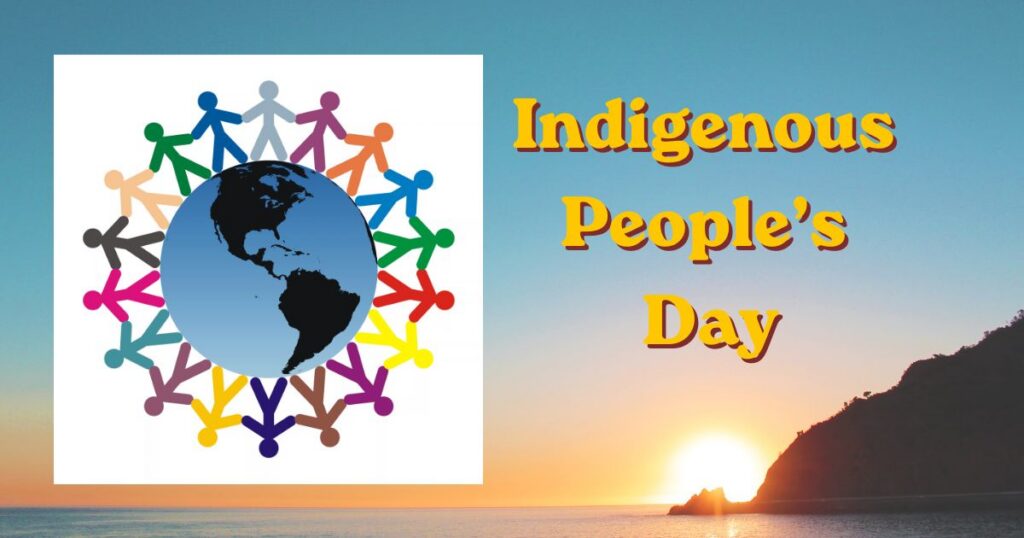 Image reads Indigenous People's Day across a photo of a sunrise over a body of water with a sharply rising shore off to the right and a graphic representation of the world from the American hemisphere with different colored "paper doll" cutouts holding hands around the world